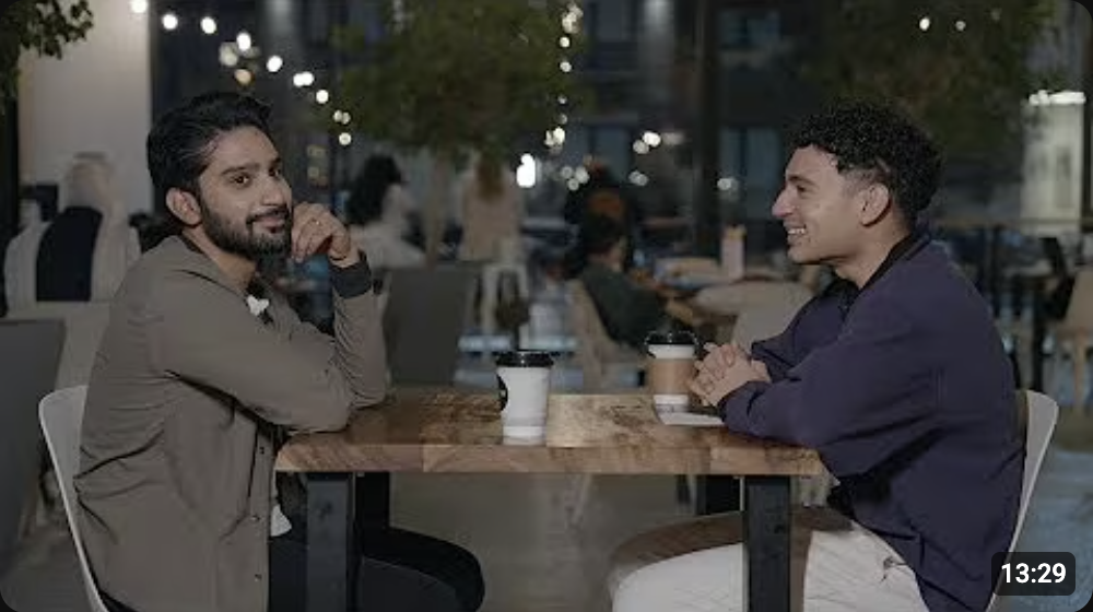 Behind the Imam, episode 2: Aslam and Shaykh Umair Haseeb at a cafe table at night